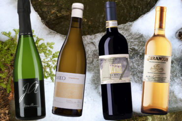 Four wine bottles against a background of a mountain stream in winter